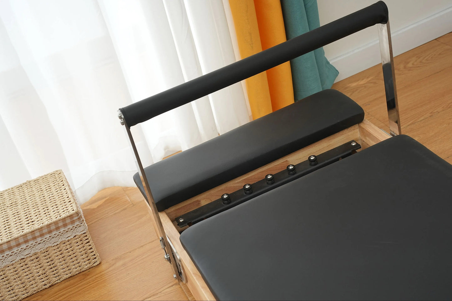Durable compact oak Pilates reformer for effective and space-saving home workouts.