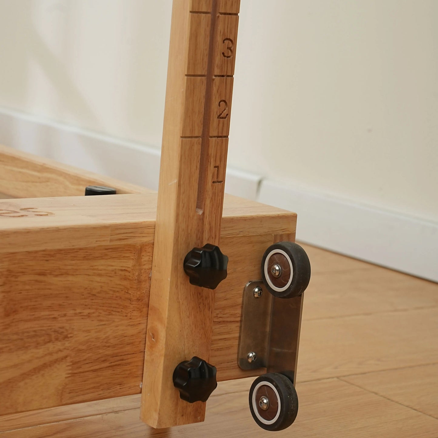 Compact oak Pilates reformer with folding design, ideal for home fitness enthusiasts.