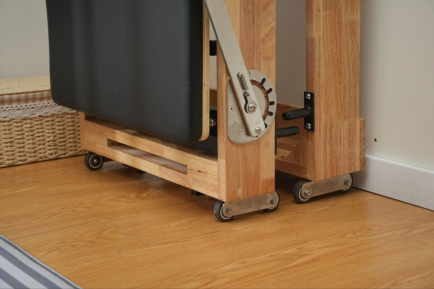 Foldable oak Pilates reformer, designed for small spaces and easy storage
